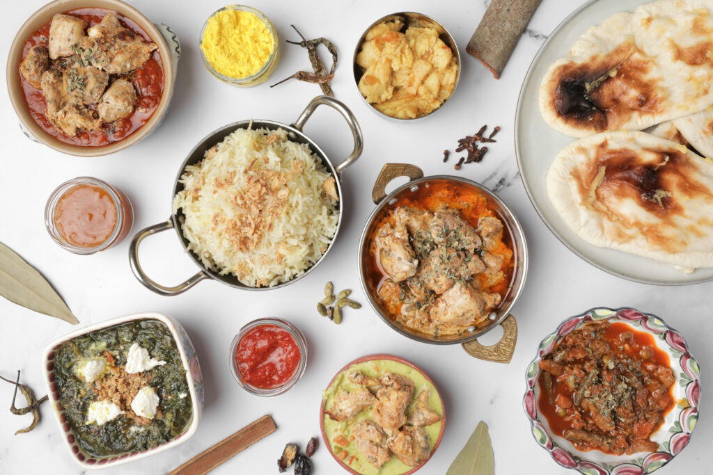 The image is of our full Indian curry menu, it has Butter chicken, Saffron Rice, Suji Halwa, Spinich Paneer, Black Tiger Prawn with Coconut Madras, Naan Bread and Garlic Naan bread. Do not forget the chutney - a spicy tomato chutney and a mango marrille chutney.
